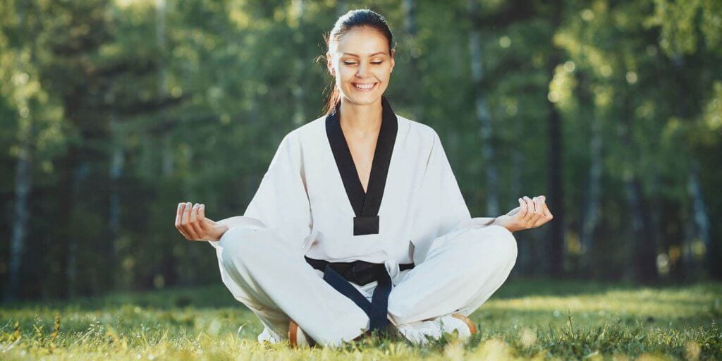 Martial Arts Lessons for Adults in Mundelein IL - Happy Woman Meditated Sitting Background